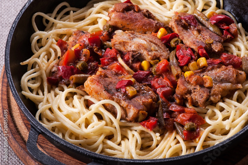 Pasta spaghetti in tomato sauce and rib meat.