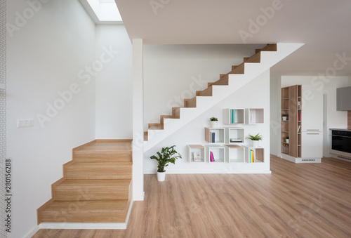 Interior of contemporary living room with wooden stairway photo