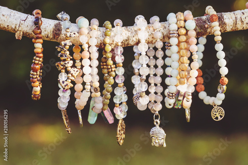 Carta da parati Collection of mineral stone beaded bracelets on natural outdoor background
