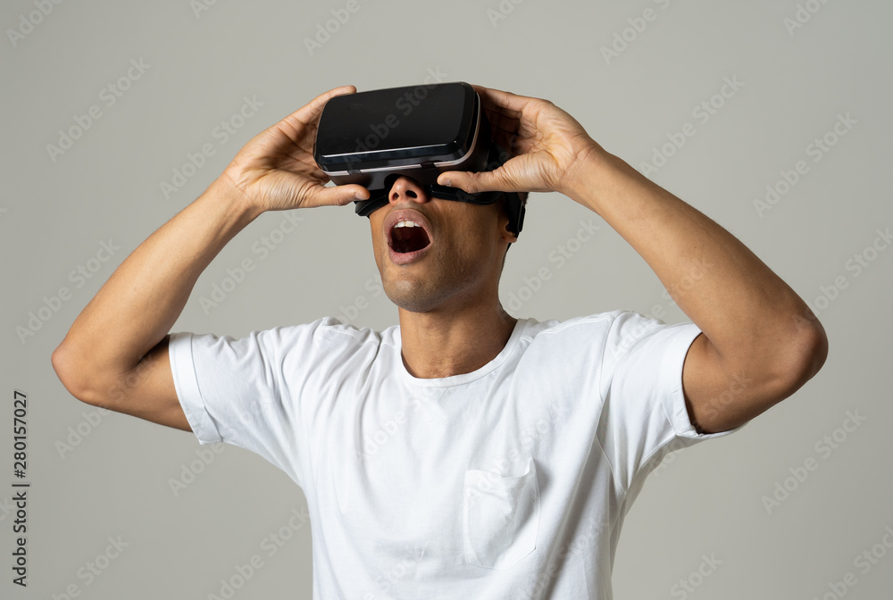 Portrait of cheerful and shocked young man wearing Virtual Reality headset exploring 3D world Portrait of cheerful and shocked young man wearing Virtual Reality headset exploring 3D world