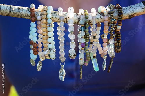 Collection of mineral stone beaded bracelets on natural outdoor background