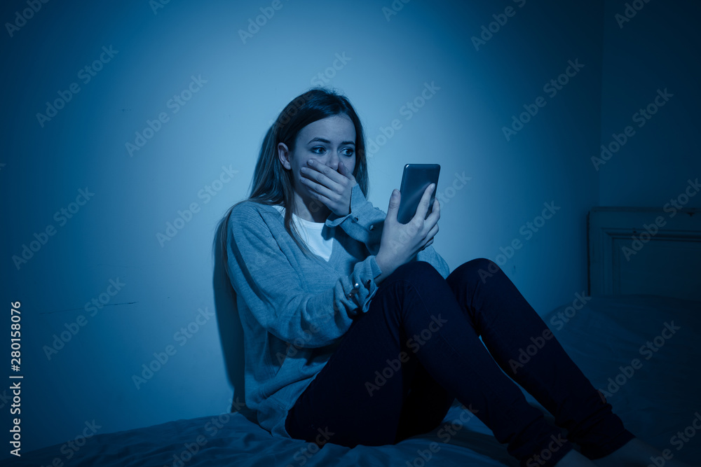 Φωτογραφία Depressed teenager girl on mobile phone victim of cyberbullying feeling sad, unh