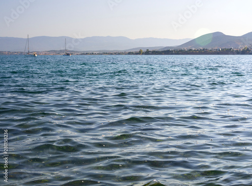 Panoramic views of sea, the mountains and yachts on Liani Ammos beach in Halkida, Greece on a Sunny summer day  the island of Evia photo