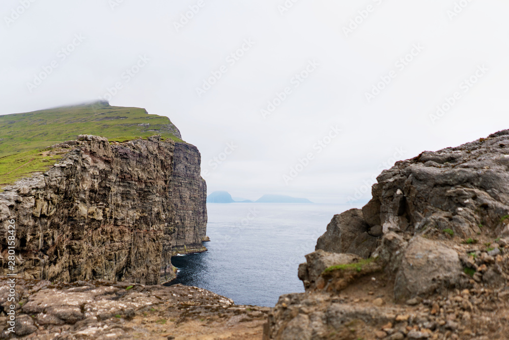 Picturesque Vagar island with its rocks above the Atlantic Ocean. Faroe Islands.