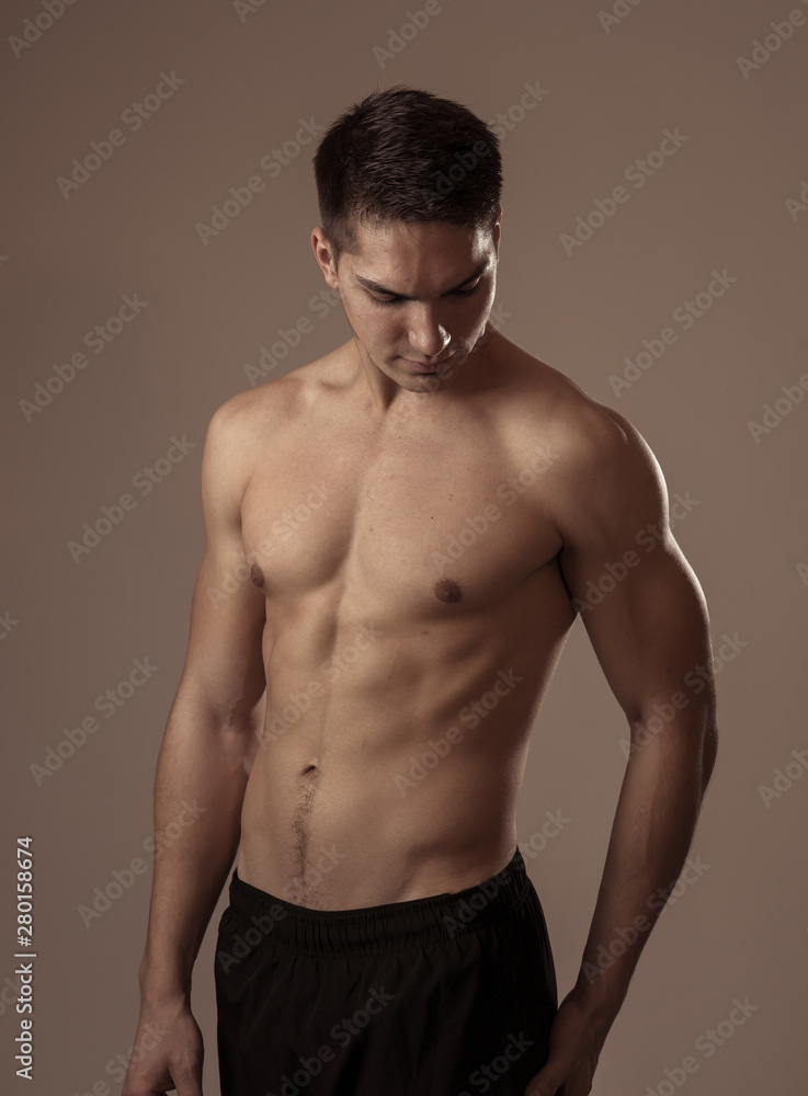 Half length portrait of strong healthy handsome Athletic man isolated on neutral background