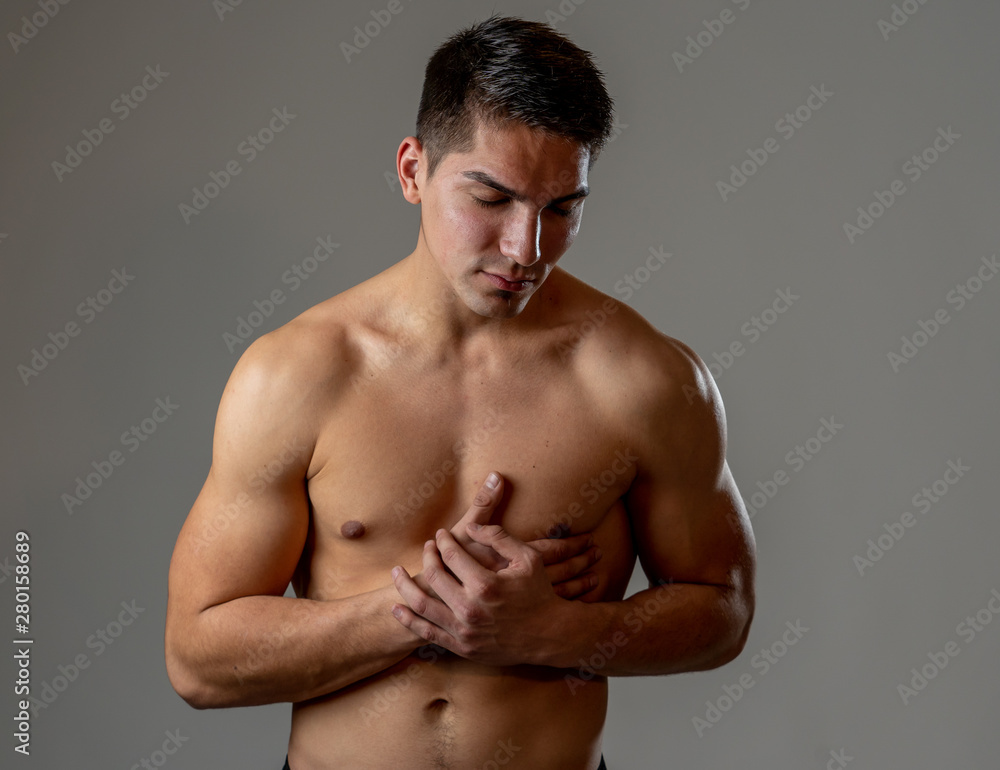 Fototapeta premium Young fit strong man suffering intense chest pain having heart attack