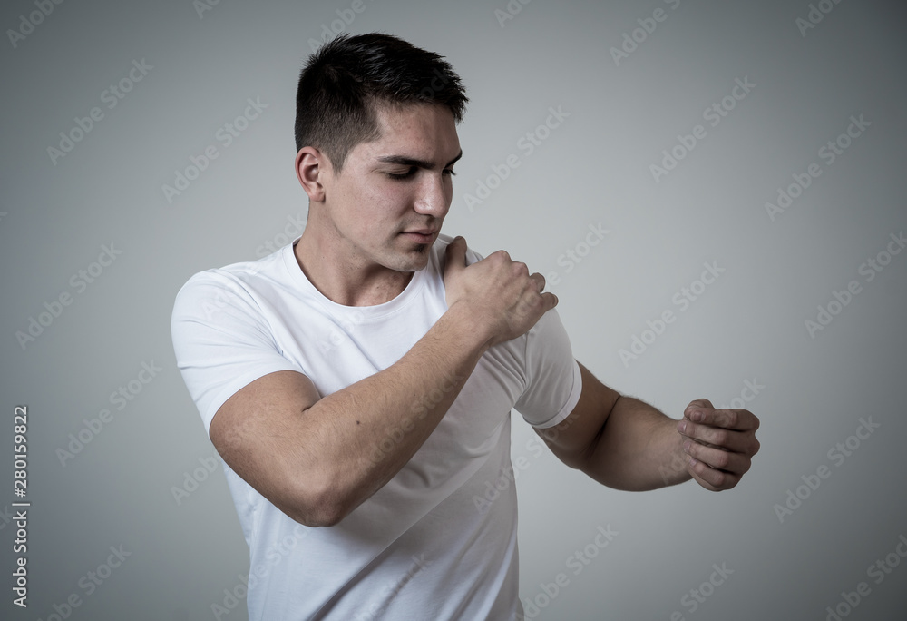 Strong young man strong pain in his shoulder after training Strong young man strong pain in his shoulder after training