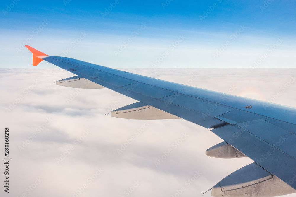 Plane wings and the sky View from the passenger window Plane wings and the sky View from the passenger window
