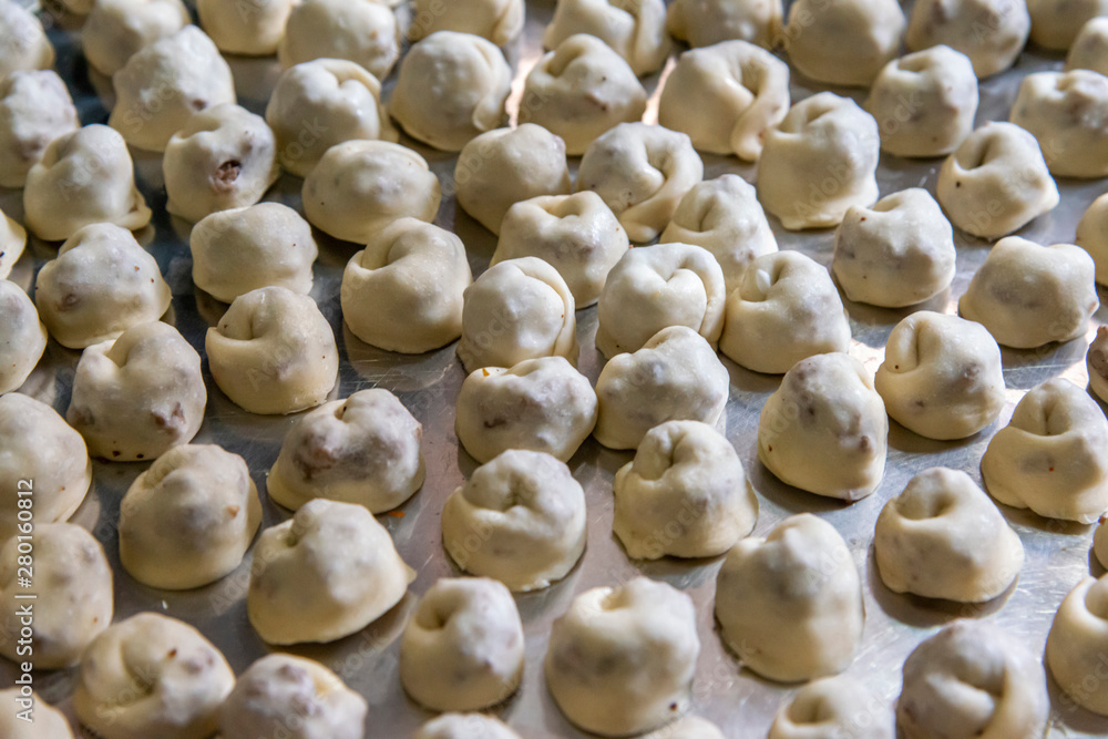 Preparing fresh tortellini stuffed with meat