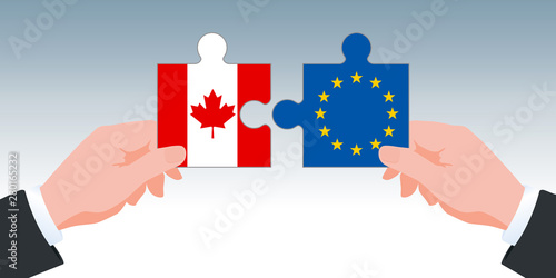 Concept de l’accord économique et commercial entre l’Union Européenne et le Canada. Le CETA est symbolisé par deux mains tenant des pièces de puzzle aux couleurs de leurs drapeaux.