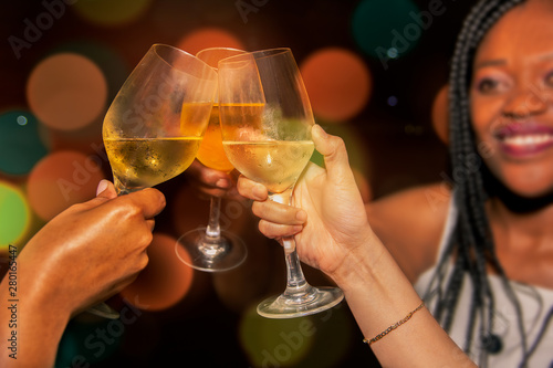 Group of women having a toast in a party. Ladies drinking champagne in the party in a club.