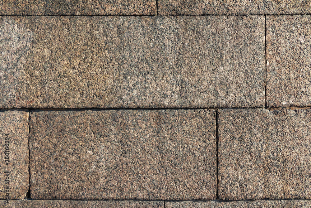 Fototapeta premium Dark brown granite stone wall texture and background. Close-Up 