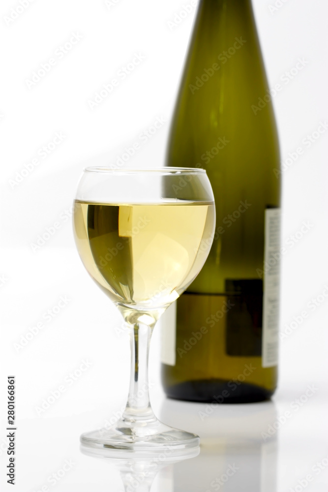 glass of white wine and bottle glass of white wine and bottle