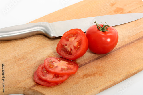 tomato and knife on cutting board