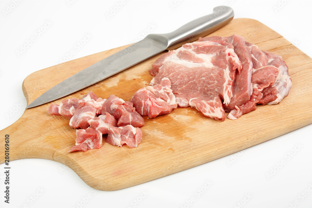 raw meat on a chopping board isolated on white raw meat on a chopping board isolated on white