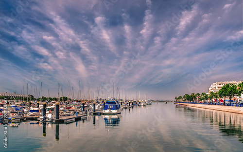 Yachts and boats in Ayamonte marina on a day with an impressive cloudscape reflecting in the water. Ayamonte is a border town next to Portugal in the province of Huelva. © Christine Bird
