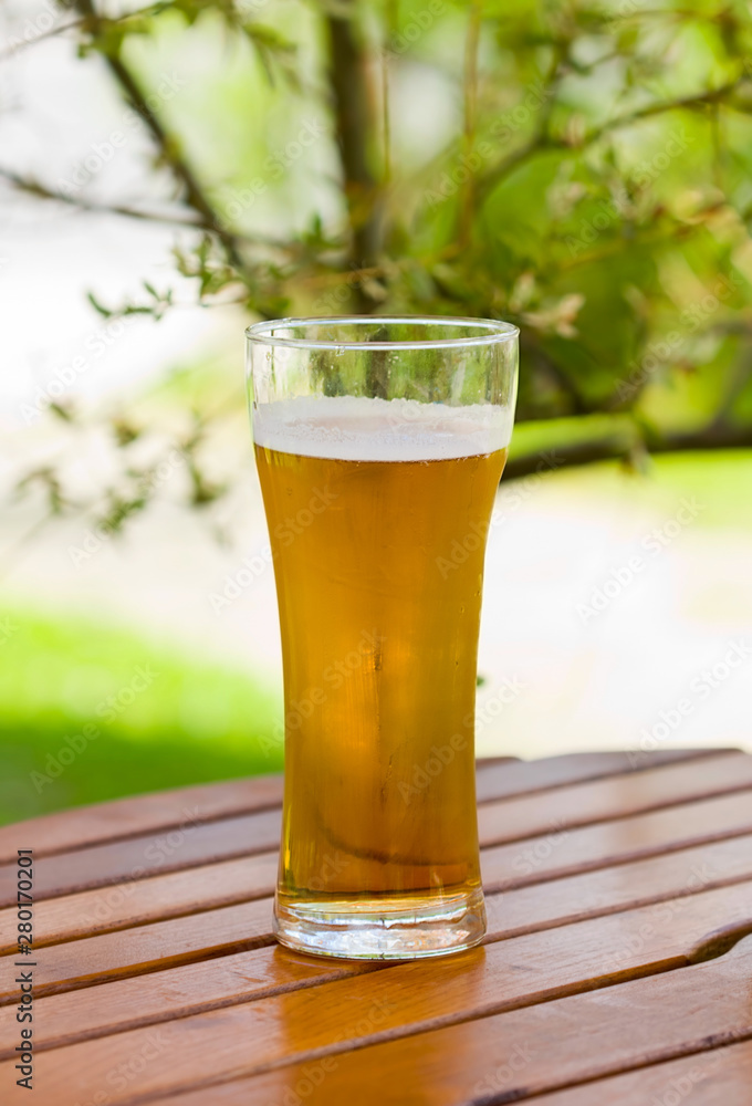 glass of beer on wooden table glass of beer on wooden table
