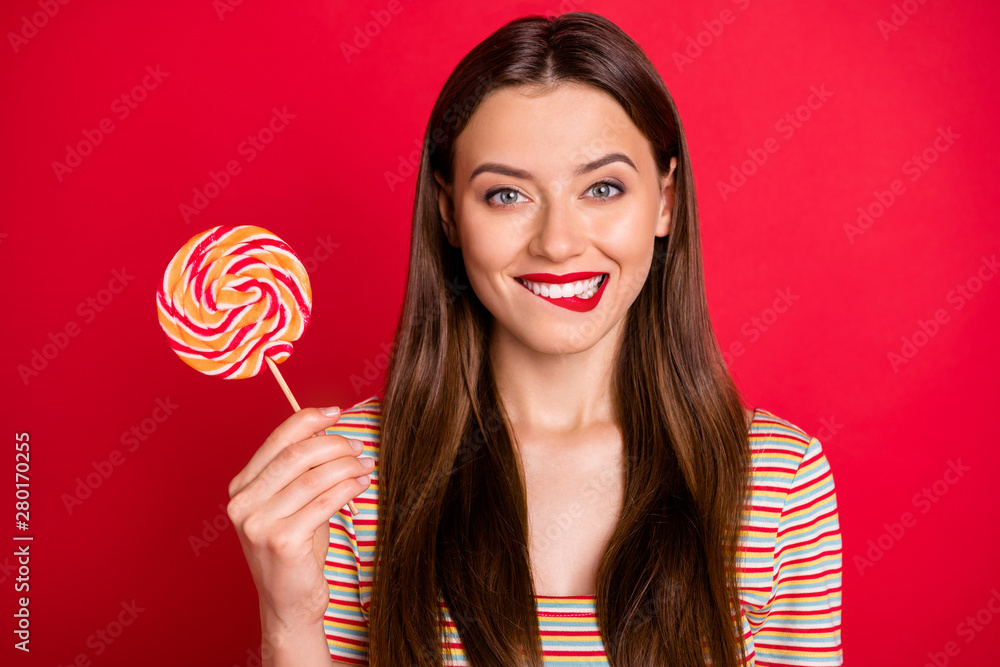 Close-up photo of pretty cute nice glad charming gorgeous lady holding swirl colorful candy on stick isolated bright background