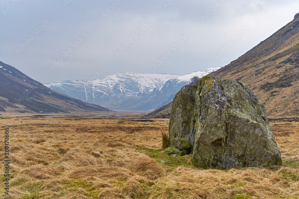 A Glacial erratic stands tall in the Valley floor at Glen Esk in the Angus Glens, on one cold Winter's day. A Glacial erratic stands tall in the Valley floor at Glen Esk in the Angus Glens, on one cold Winter's day.