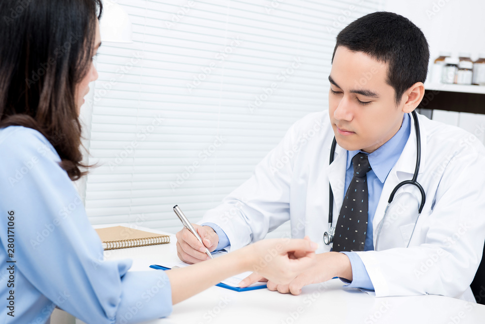 Young woman patient consulting with Asian male doctor