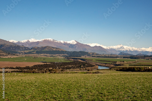 River flowing through agricultural farm land towards the Southern Alps