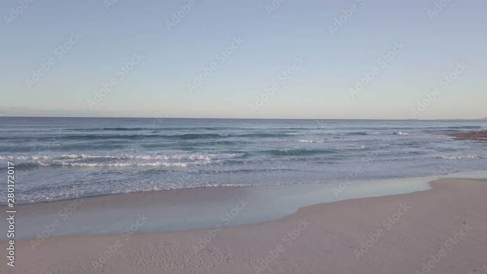 Aerial view of a beautiful sandy beach with sand dunes in Australia at sunset Aerial view of a beautiful sandy beach with sand dunes in Australia at sunset