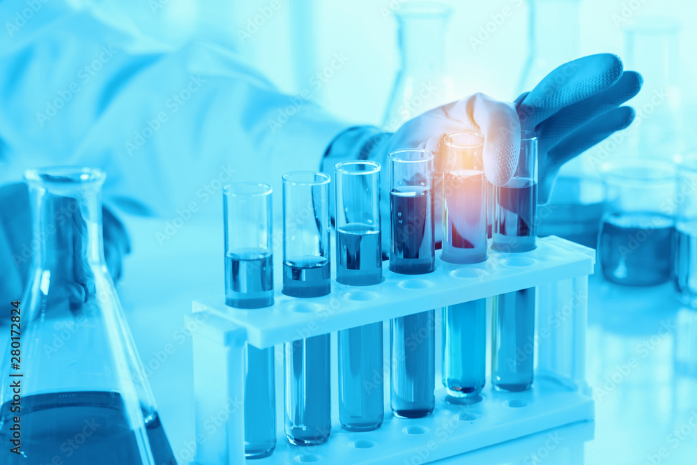 scientist with equipment and science experiments, laboratory glassware containing chemical liquid for research or analyzing a sample into test tube in laboratory scientist with equipment and science experiments, laboratory glassware containing chemical liquid for research or analyzing a sample into test tube in laboratory