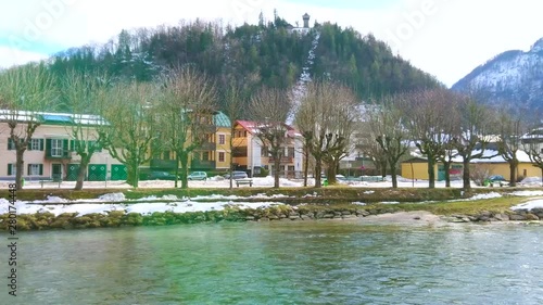 The scenic colorful mansions on the bank of Traun river with a view on Siriuskogl mount on the background, Bad Ischl, Salzkammergut, Austria photo