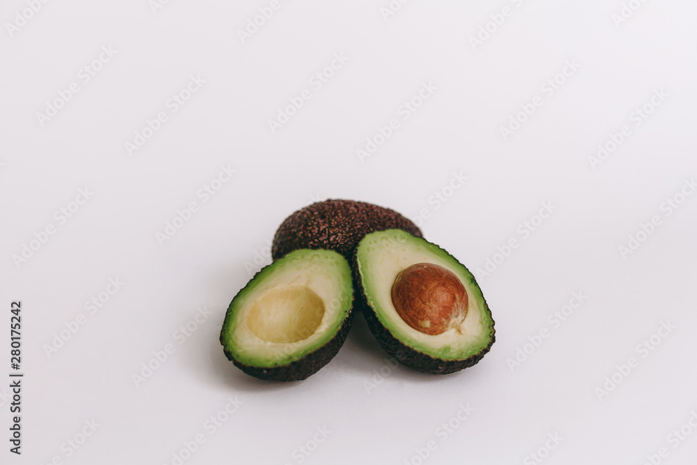half of avocado on white background. top view