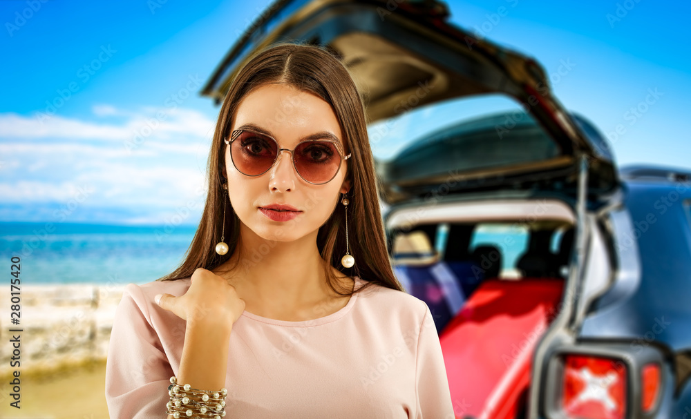 Summer background with a girl and black car in a beautiful sunny sandy beach and blue ocean view. Summer background with a girl and black car in a beautiful sunny sandy beach and blue ocean view.