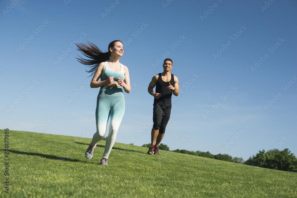 Man and woman running outdoor in a park Man and woman running outdoor in a park