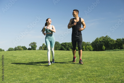Man and woman running outdoor in a park