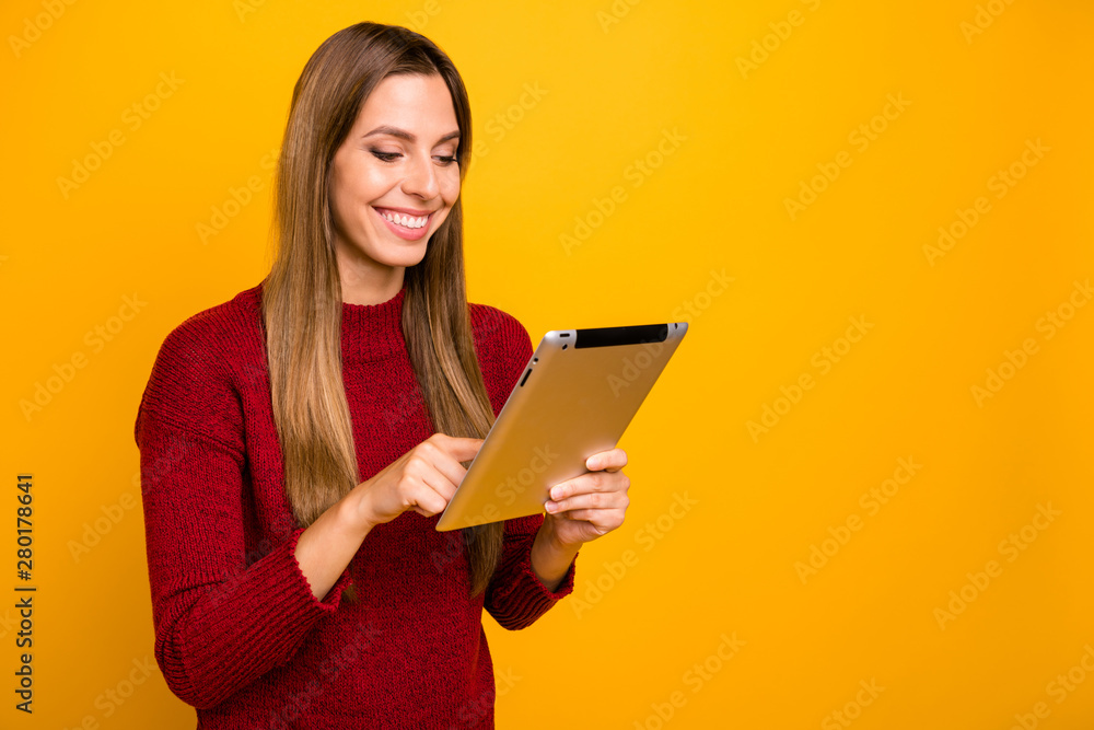 Pretty lady holding e-reader checking report wear knitted pullover isolated yellow background Pretty lady holding e-reader checking report wear knitted pullover isolated yellow background