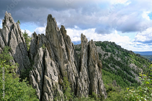 Natural landscape mountain rocks, slopes of Southern Urals. Beautiful view from top of rock mountain in Urals. summer landscape in mountains. theme for travel backdrop. national Park Taganay, Russia