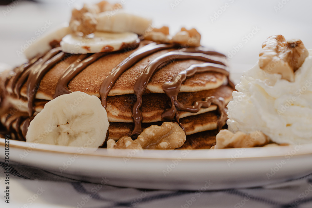sirope de chocolate sobre pancake casero con nueces y platano sirope de chocolate sobre pancake casero con nueces y platano