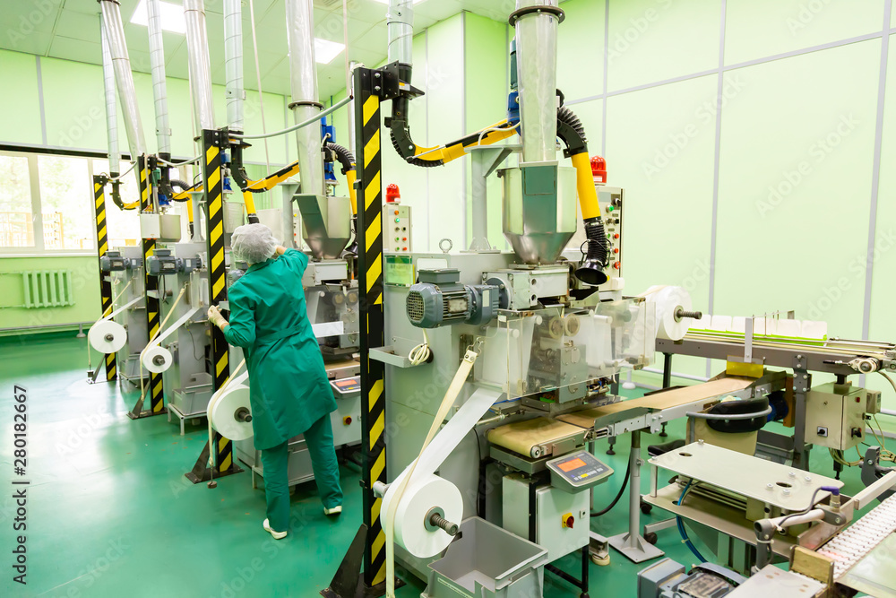 Factory and industrial concept. Worker with technological equipment at factory Factory and industrial concept. Worker with technological equipment at factory