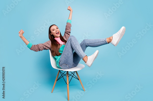 Full length body size photo of excited cheerful mad delightful emotional lady raising fists up having great mood isolated bright background