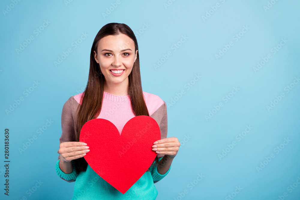 Portrait of charming pretty nice glad lady holding large bright colored heart shaped card with copyspace in hands isolated vivid background Portrait of charming pretty nice glad lady holding large bright colored heart shaped card with copyspace in hands isolated vivid background