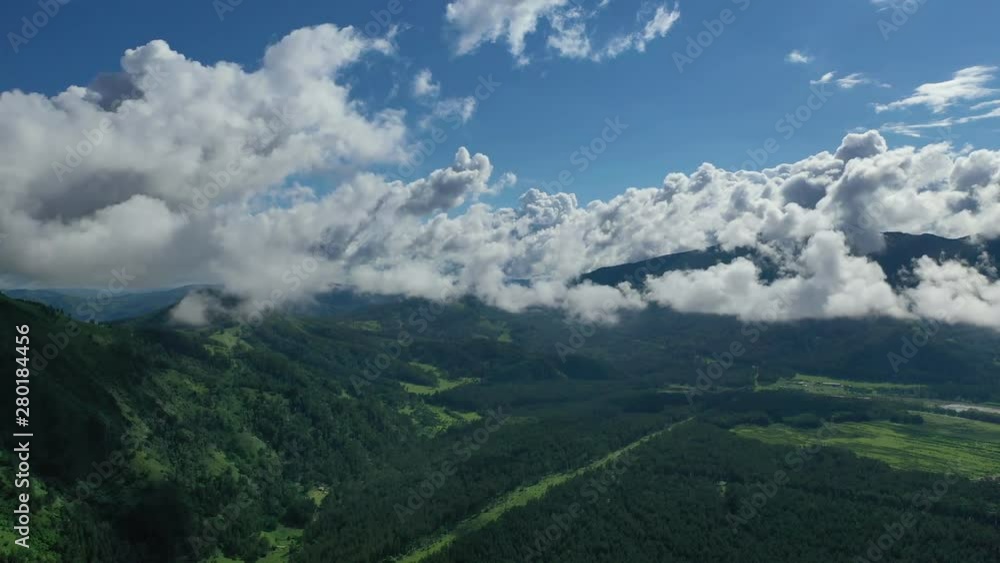 Aerial view, beautiful clouds above green valley in the Altai mountains during summer, Russia. Aerial view, beautiful clouds above green valley in the Altai mountains during summer, Russia.