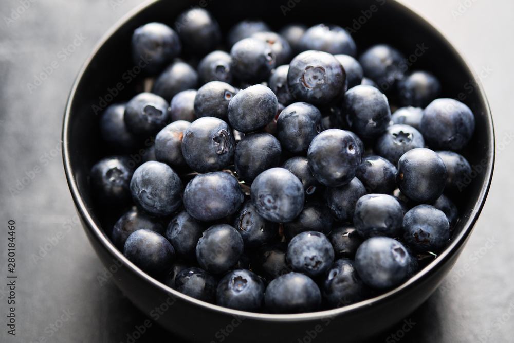 Freshly picked blueberries in black bowl on the table. Freshly picked blueberries in black bowl on the table.