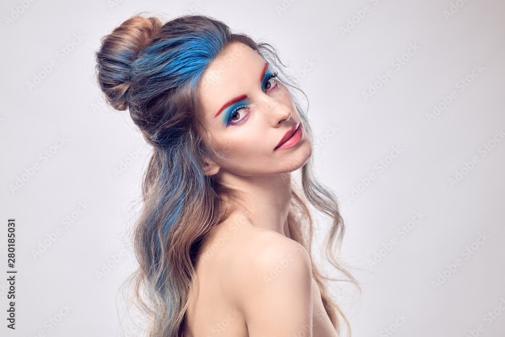 Beauty fashion woman portrait. Sensual blonde with art paint makeup, styling wavy hair, healthy skin. Beautiful slim model girl, fashionable Dyed hairstyle. Creative professional fantasy make up