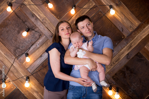 Happy Young Caucasian Family Posing in Studio