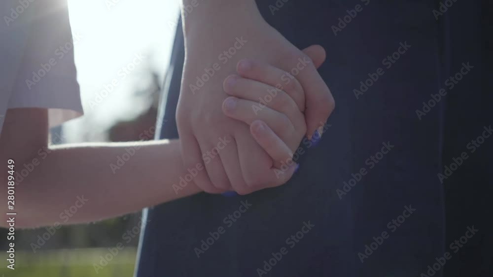 Older sister and younger brother holding hands in the summer park in ...