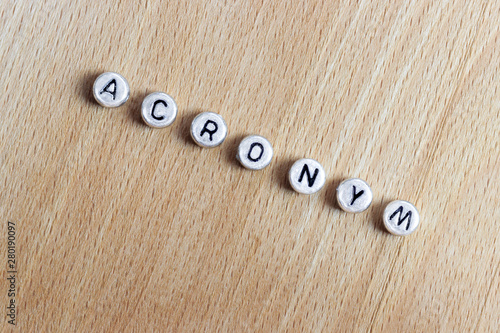 acronum, the inscription of plastic letters on a wooden board photo