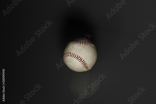still life: old baseball ball in black background