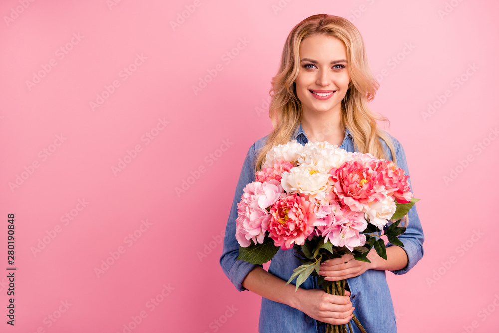 Portrait of her she nice-looking attractive lovely sweet gorgeous pretty cheerful cheery wavy-haired girl holding in hands flowers isolated over pink pastel background