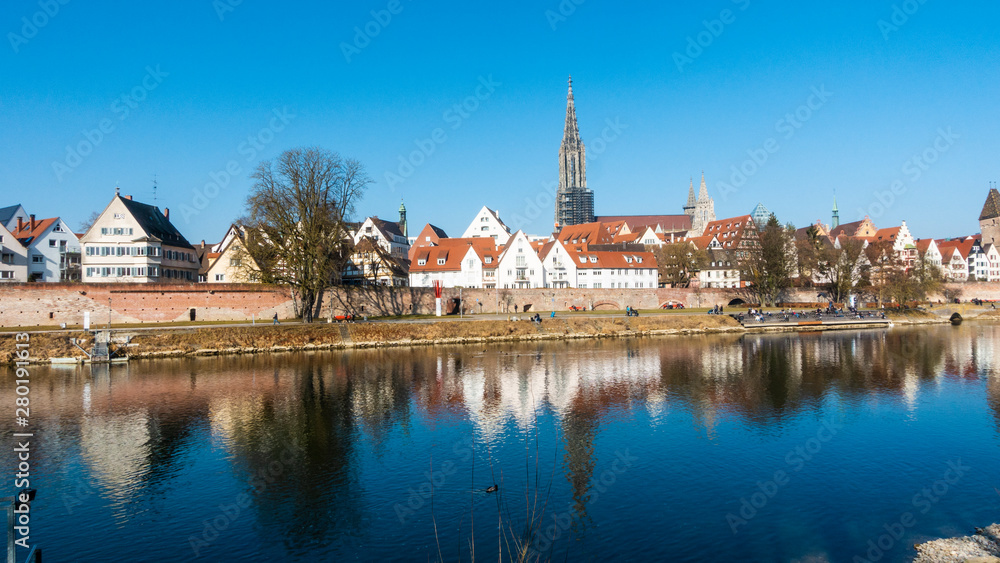 Panorama picture of Ulmer Münster cathedral with river Donau in the morning sun