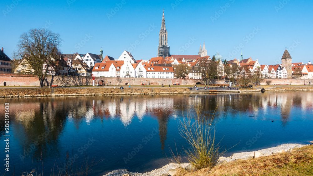 Panorama picture of Ulmer Münster cathedral with river Donau in the morning sun