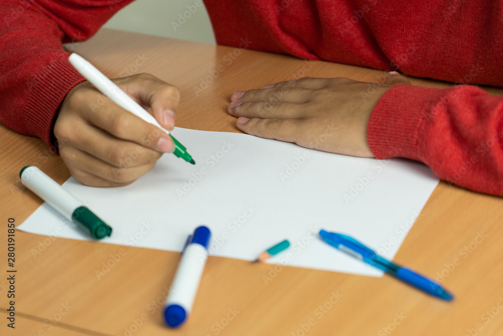 teenager with a felt-tip pen in her fingers prepared for study