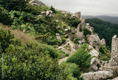 Green hills and stone towers of the 8th century The Moorish Castle over town Sintra. Historical landscape in Portugal and a UNESCO world heritage site